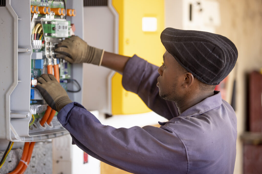 An engineer works on a power connection at Powerhive in Kisii.