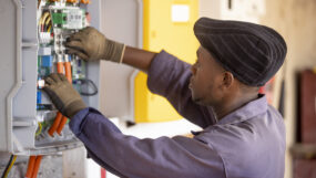 An engineer works on a power connection at Powerhive in Kisii.